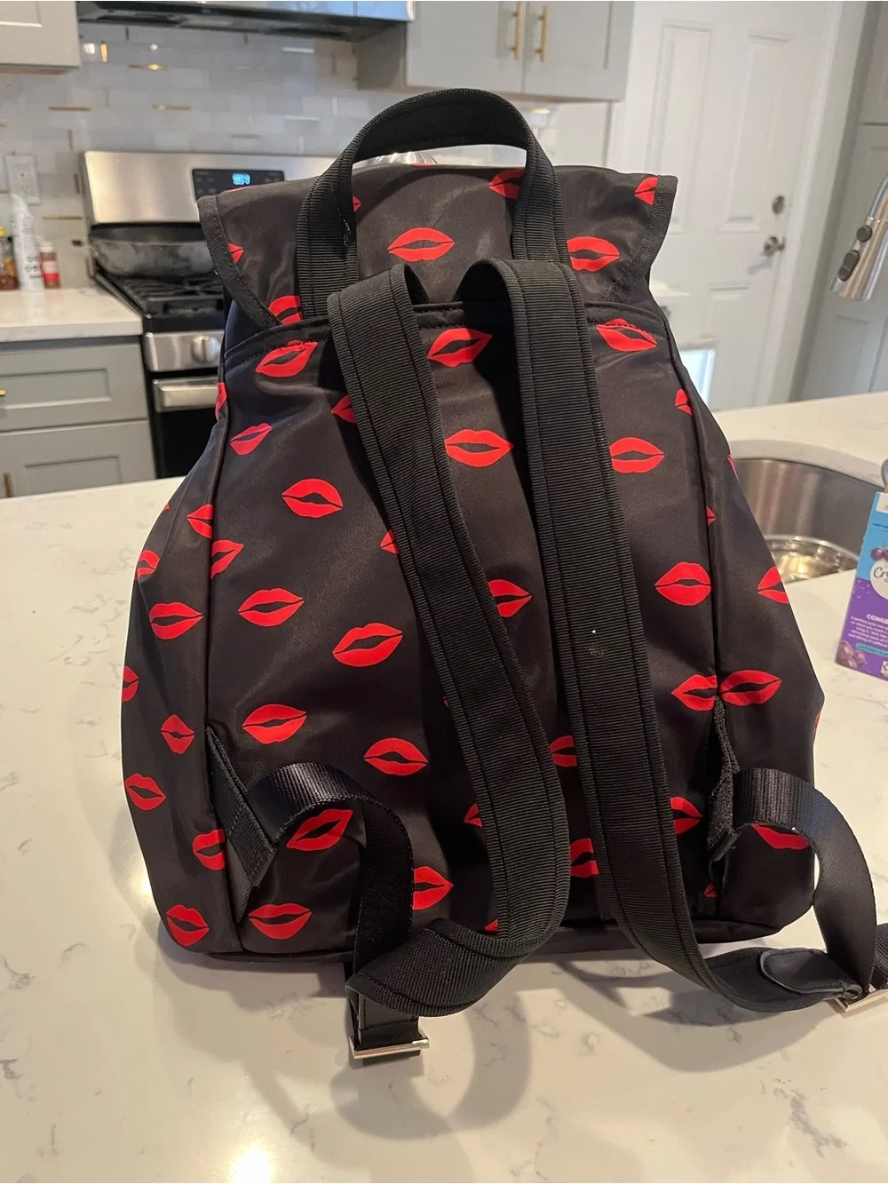 kate spade Black Backpack with Red Lip Print Pattern